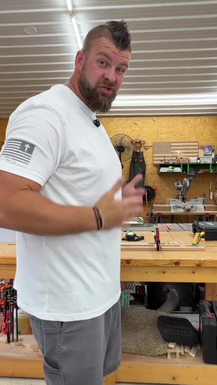 Bigger man in a white Patriot Crew tee with his hand on his chest